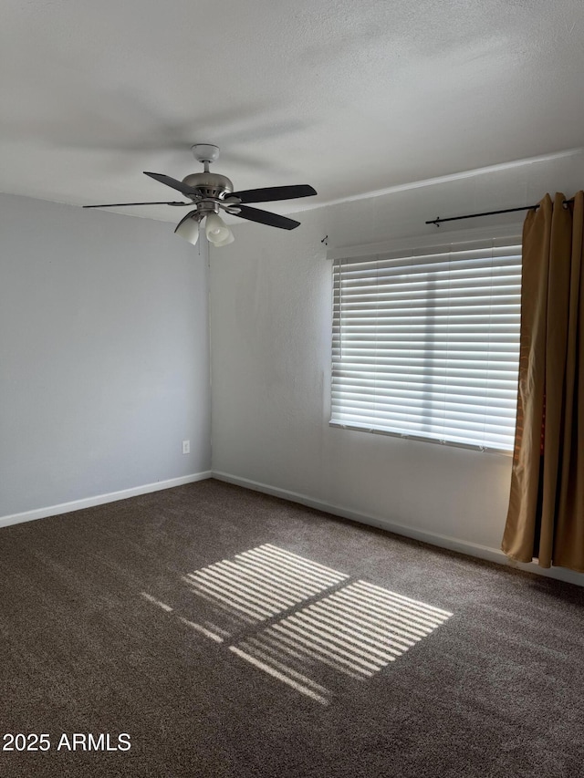 unfurnished room featuring a textured ceiling, carpet floors, ceiling fan, and baseboards