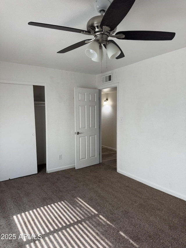 unfurnished bedroom with a ceiling fan, a closet, carpet flooring, and visible vents