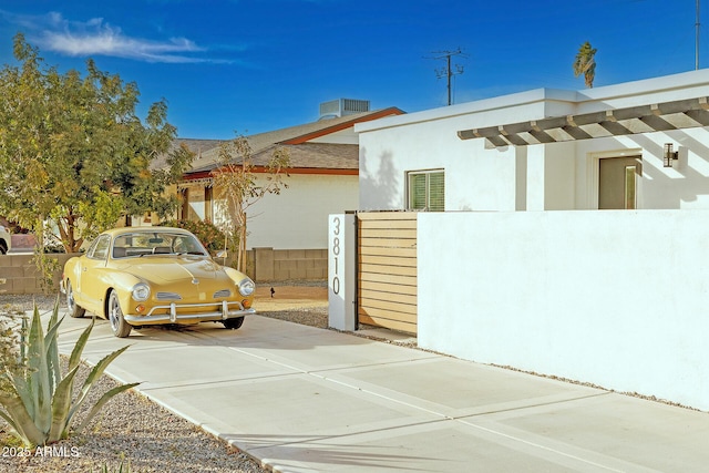 view of side of home with central air condition unit