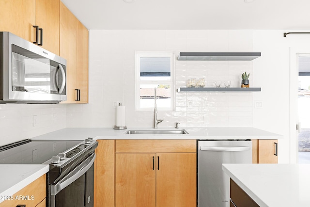 kitchen with appliances with stainless steel finishes, tasteful backsplash, and sink