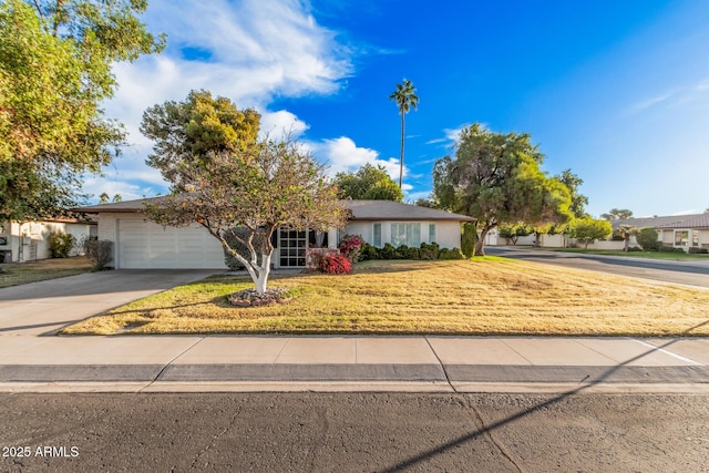 view of front of property featuring a front yard and a garage