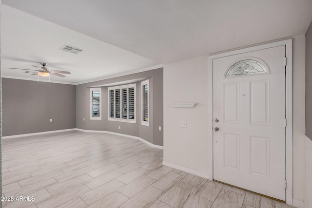 foyer entrance featuring ceiling fan and crown molding