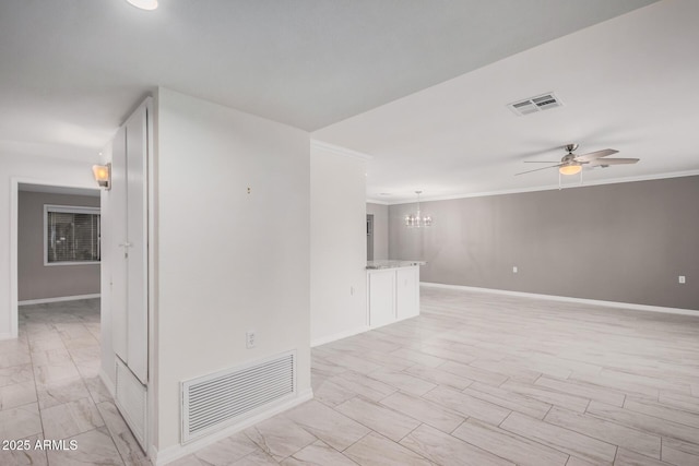 unfurnished room featuring ceiling fan with notable chandelier and ornamental molding