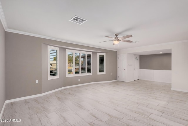 spare room with ceiling fan and ornamental molding