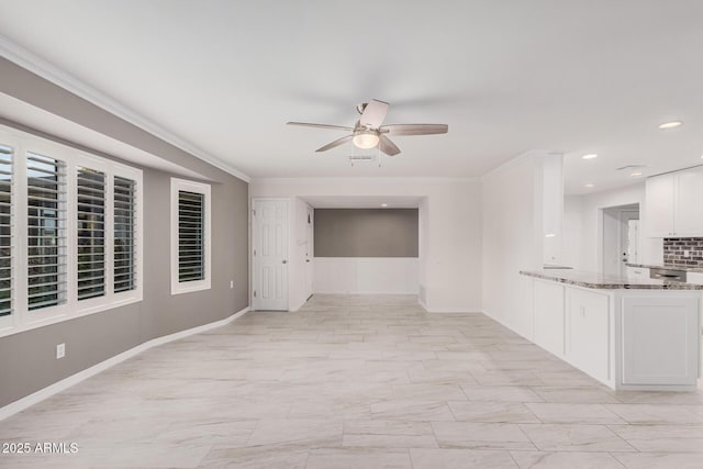 unfurnished living room featuring ceiling fan and ornamental molding