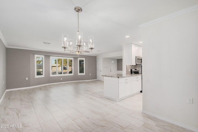 kitchen with light stone countertops, white cabinets, and ornamental molding