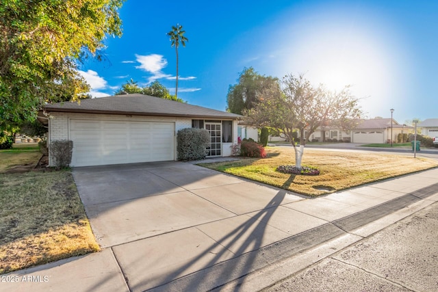 ranch-style home with a front lawn and a garage