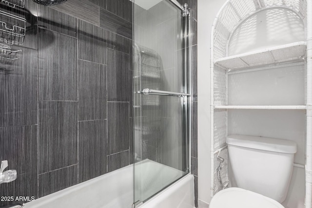 bathroom with shower / bath combination with glass door and toilet