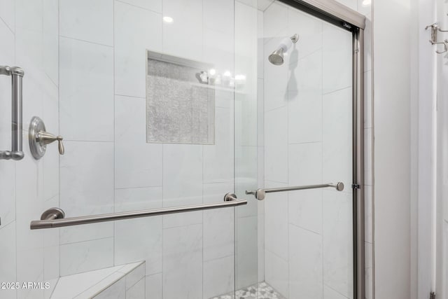 bathroom featuring a shower with door