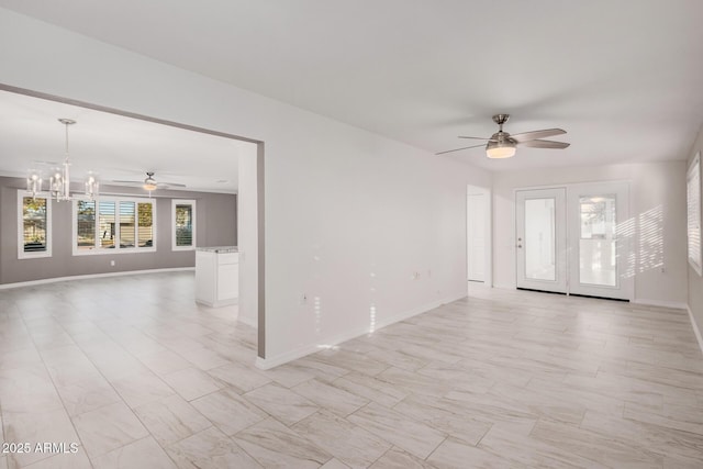 unfurnished room featuring ceiling fan with notable chandelier