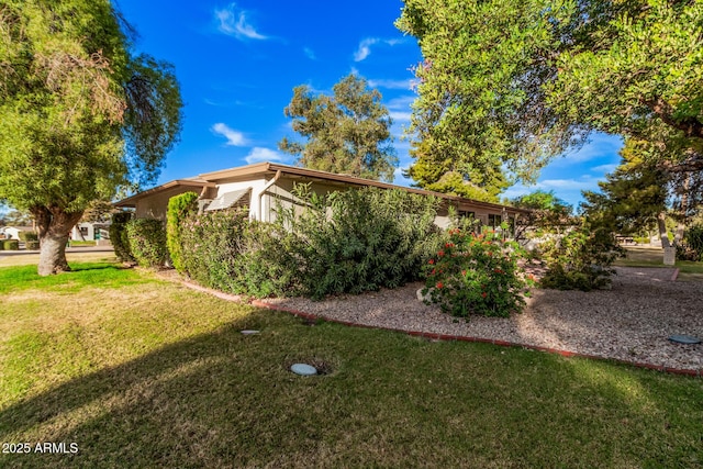 view of side of property with a lawn