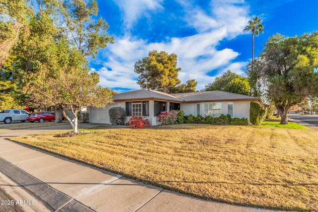 single story home featuring a front yard and a garage