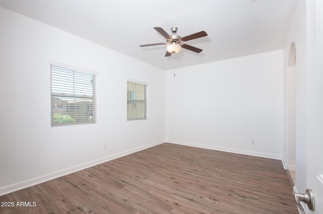 1367 S Country Club Dr S Unit 1125, Mesa, AZ 85210 - unfurnished room featuring a ceiling fan, wood finished floors, and arched walkways