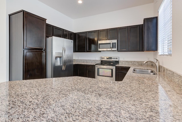 1367 S Country Club Dr S Unit 1125, Mesa, AZ 85210 - kitchen with stainless steel appliances, light stone countertops, plenty of natural light, dark brown cabinets, and recessed lighting