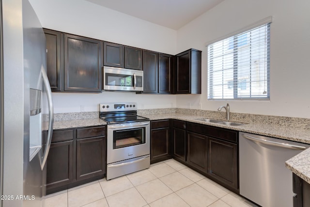 1367 S Country Club Dr S Unit 1125, Mesa, AZ 85210 - kitchen featuring stainless steel appliances, light tile patterned flooring, dark brown cabinetry, and light stone countertops