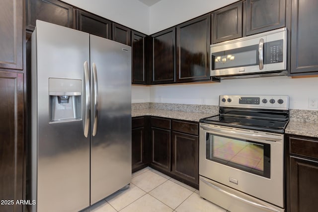 1367 S Country Club Dr S Unit 1125, Mesa, AZ 85210 - kitchen featuring stainless steel appliances, light tile patterned flooring, dark brown cabinetry, and light stone counters