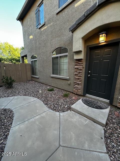 1350 S Greenfield Rd Unit 1219, Mesa, AZ 85206 - view of exterior entry featuring stucco siding and a patio area
