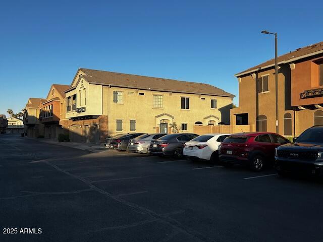 1350 S Greenfield Rd Unit 1219, Mesa, AZ 85206 - view of building exterior with uncovered parking and a residential view