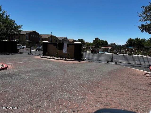 1350 S Greenfield Rd Unit 1219, Mesa, AZ 85206 - view of decorative street featuring a gate, a gated entry, curbs, and a residential view
