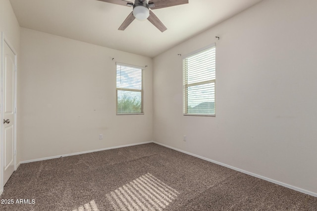 carpeted spare room featuring ceiling fan