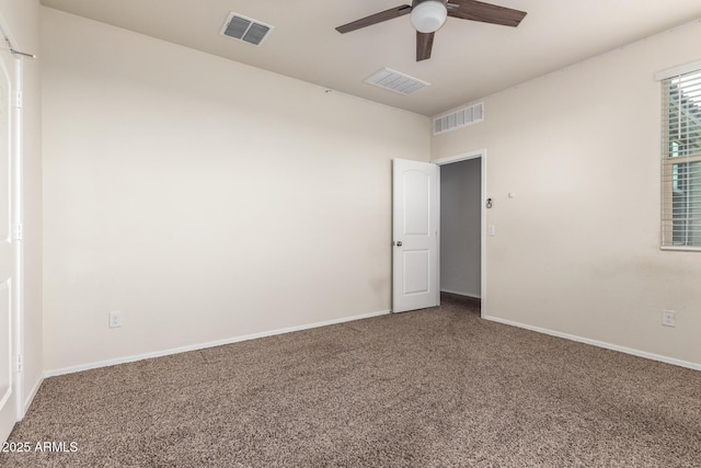 carpeted empty room featuring ceiling fan