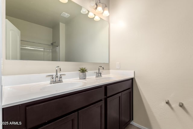 bathroom featuring walk in shower and vanity