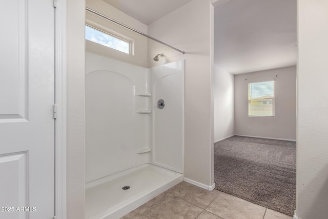 bathroom with tile patterned flooring and a shower