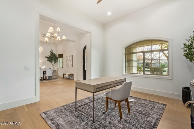 office space with a notable chandelier and light hardwood / wood-style floors