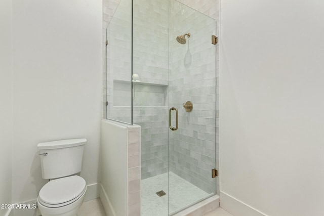 bathroom featuring toilet and an enclosed shower