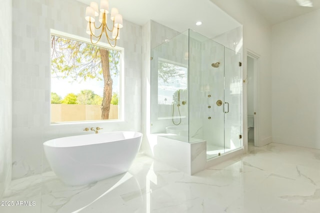 bathroom with a chandelier and independent shower and bath