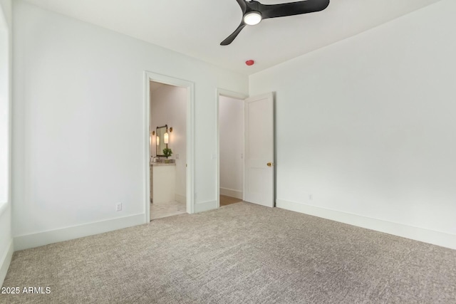 unfurnished bedroom featuring ceiling fan, ensuite bathroom, and carpet flooring