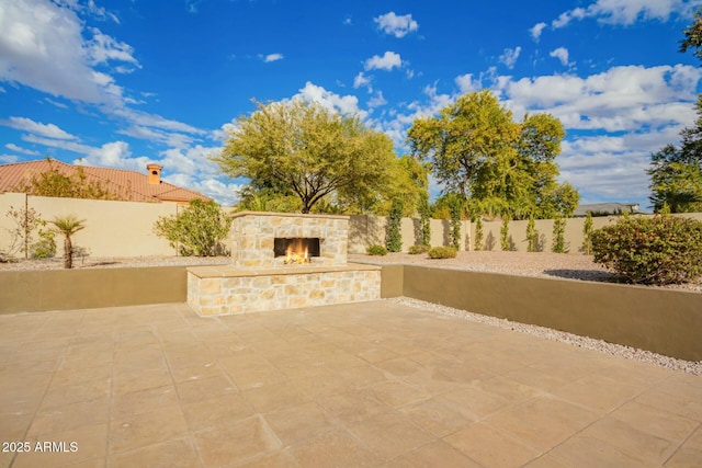 view of patio / terrace with an outdoor stone fireplace