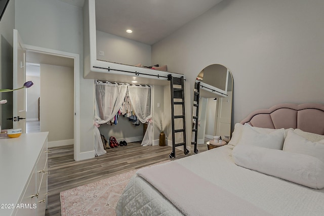 3662 E Megan St, Gilbert, AZ 85295 - bedroom with arched walkways, baseboards, recessed lighting, and wood finished floors