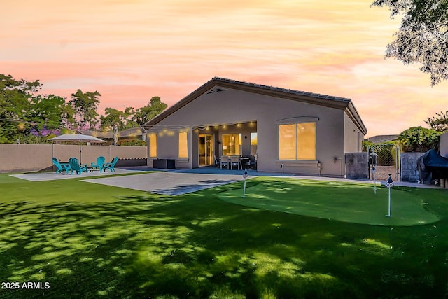 3662 E Megan St, Gilbert, AZ 85295 - back of house at dusk featuring fence private yard, stucco siding, and a patio area