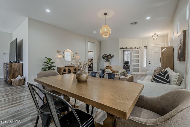 3662 E Megan St, Gilbert, AZ 85295 - dining space with recessed lighting, baseboards, a barn door, and light wood-style floors