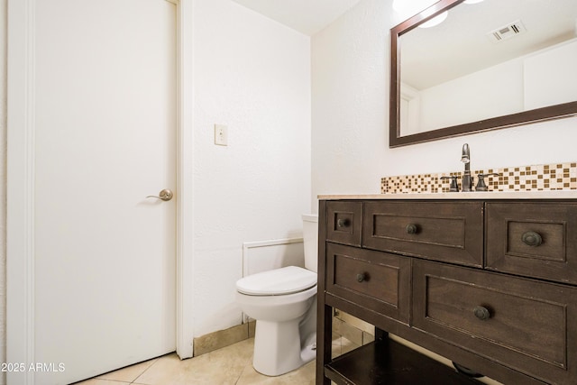 bathroom with vanity, toilet, and tile patterned flooring