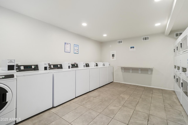 laundry room featuring light tile patterned floors, washer and clothes dryer, and stacked washer / dryer