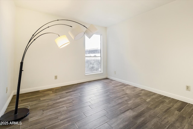 spare room with dark hardwood / wood-style flooring