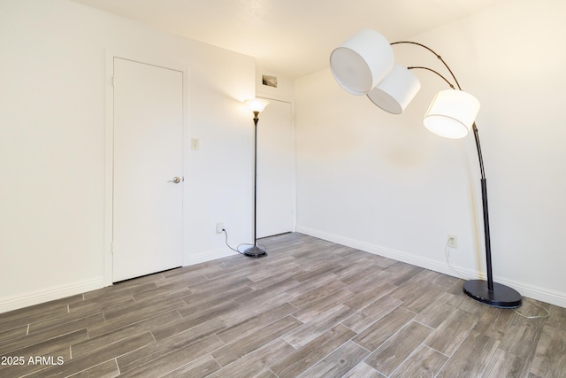 empty room with hardwood / wood-style flooring