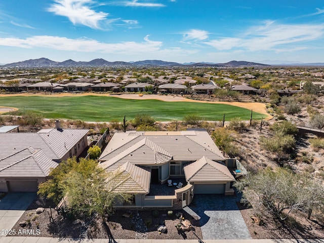 drone / aerial view featuring golf course view and a mountain view