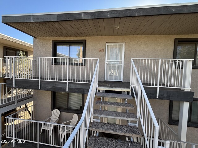 property entrance featuring stucco siding