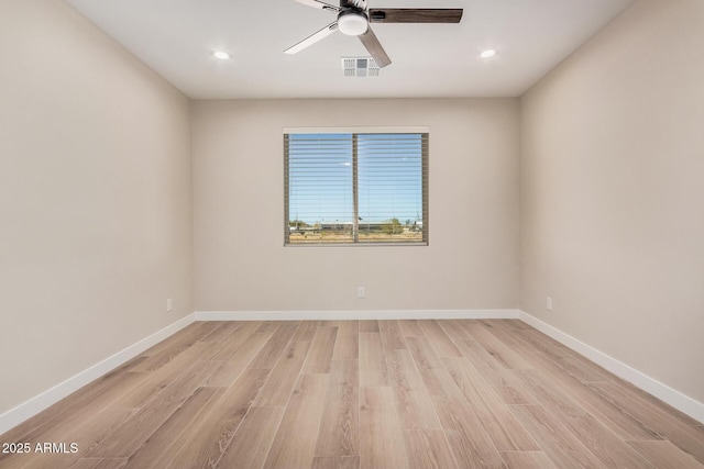 spare room with light hardwood / wood-style flooring and ceiling fan