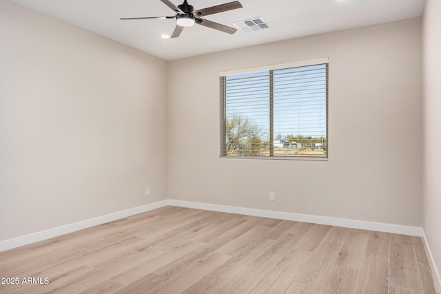 spare room with light hardwood / wood-style flooring and ceiling fan