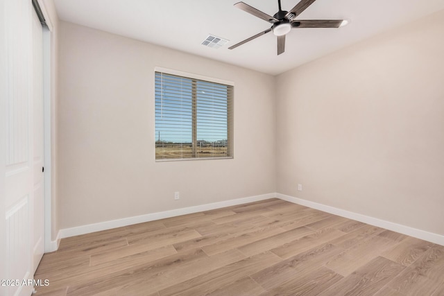 spare room with ceiling fan and light hardwood / wood-style flooring