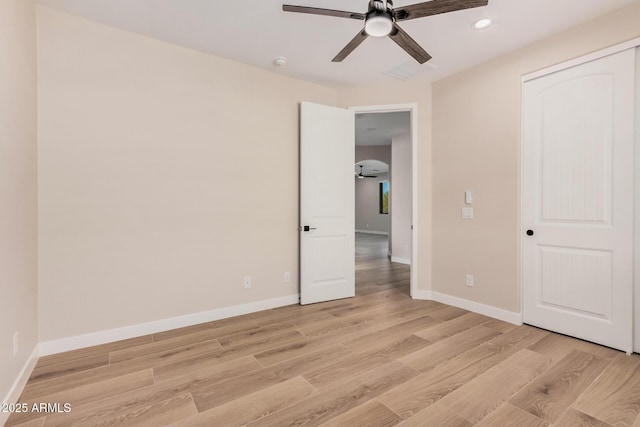 unfurnished bedroom with ceiling fan, a closet, and light hardwood / wood-style flooring