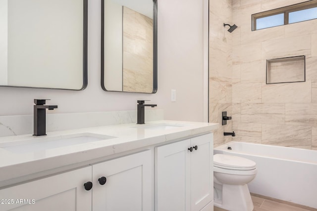 full bathroom with tiled shower / bath, vanity, and toilet