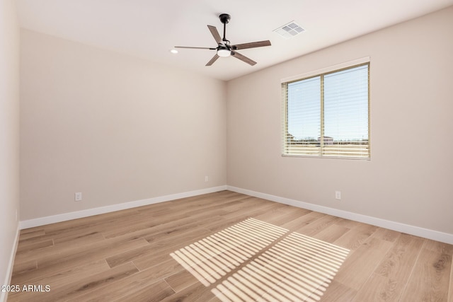 empty room featuring ceiling fan and light wood-type flooring