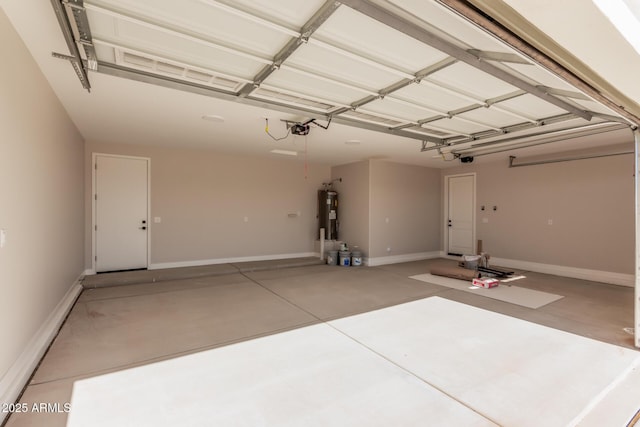 garage with a garage door opener and water heater