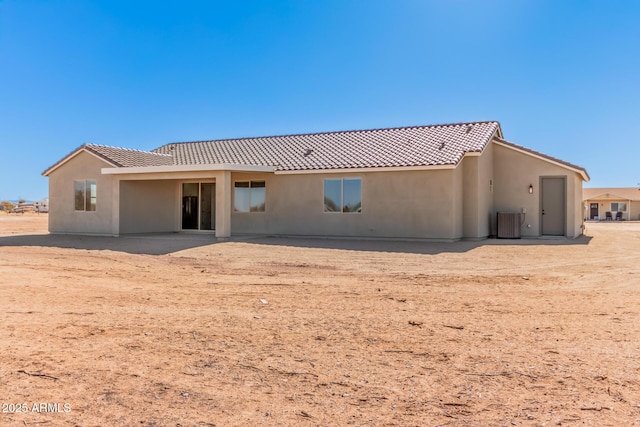 back of property featuring cooling unit and a patio area