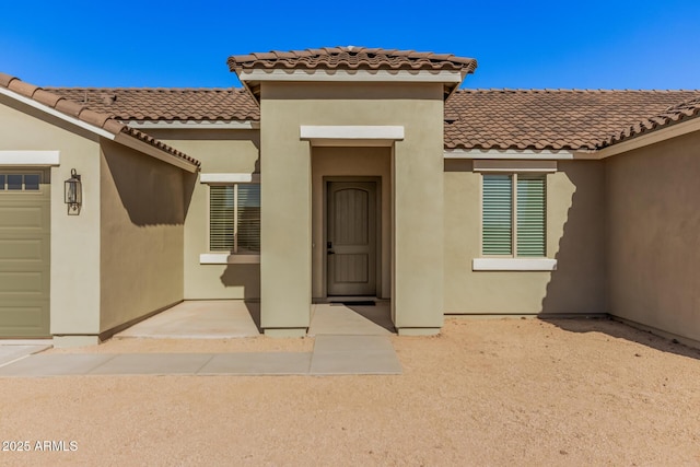 doorway to property with a garage